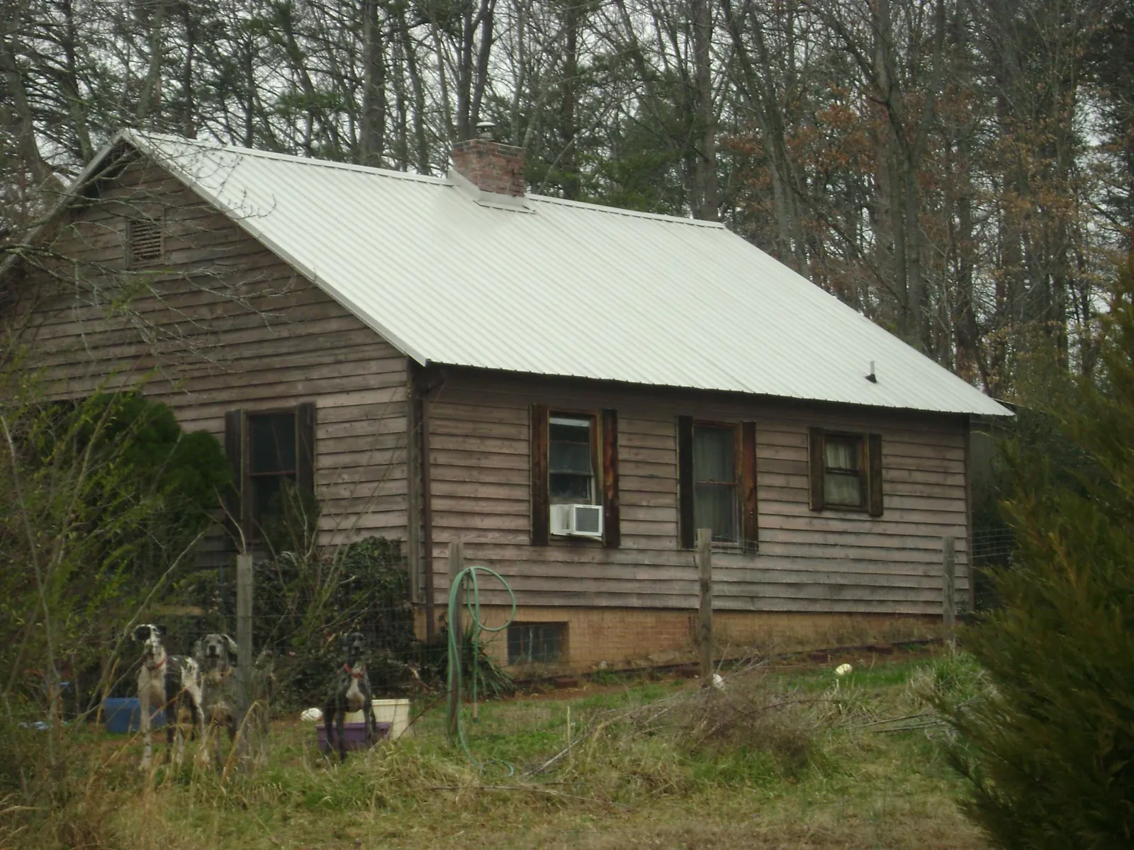 White metal roof on an old wood sided farmhouse, from a Asphalt Shingle Roof Repair job in Floyd